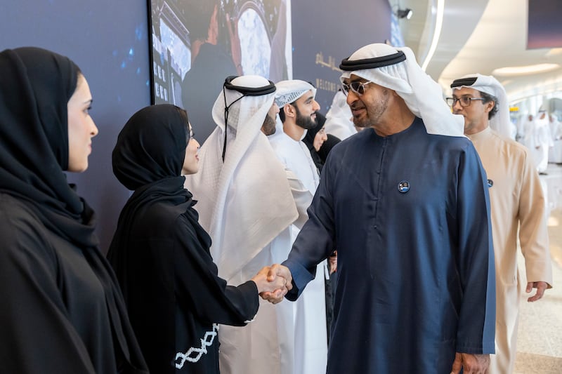 President Sheikh Mohamed greets a member of the Mohammed bin Rashid Space Centre. Photo: UAE Presidential Court 