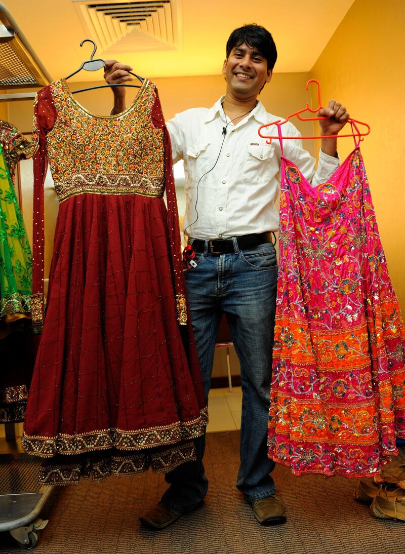 Sayed Faisal, wardrobe manager, The Merchants of Bollywood, holds up two costumes worn by lead dancer Carol Furtado.