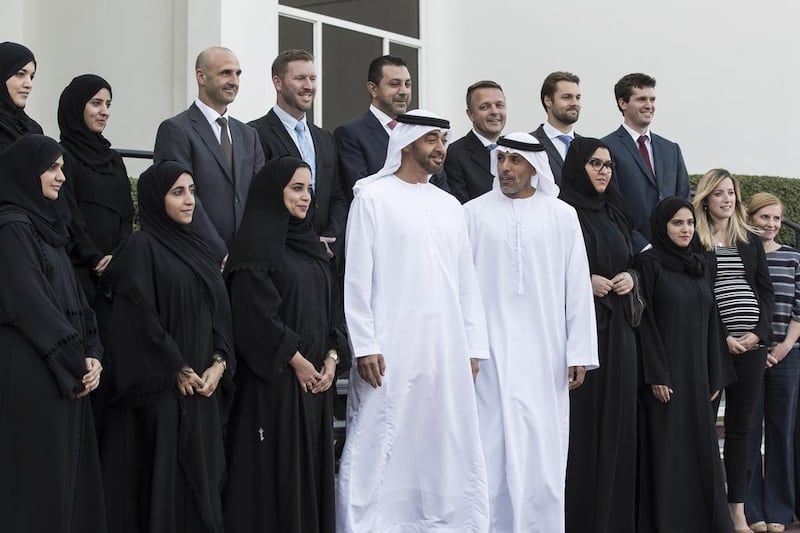Sheikh Mohammed bin Zayed with Sheikh Ahmed bin Tahnoon, Chairman of the National Service Authority (front row, fifth left) and employees from the National Service Authority. Ryan Carter / Crown Prince Court - Abu Dhabi