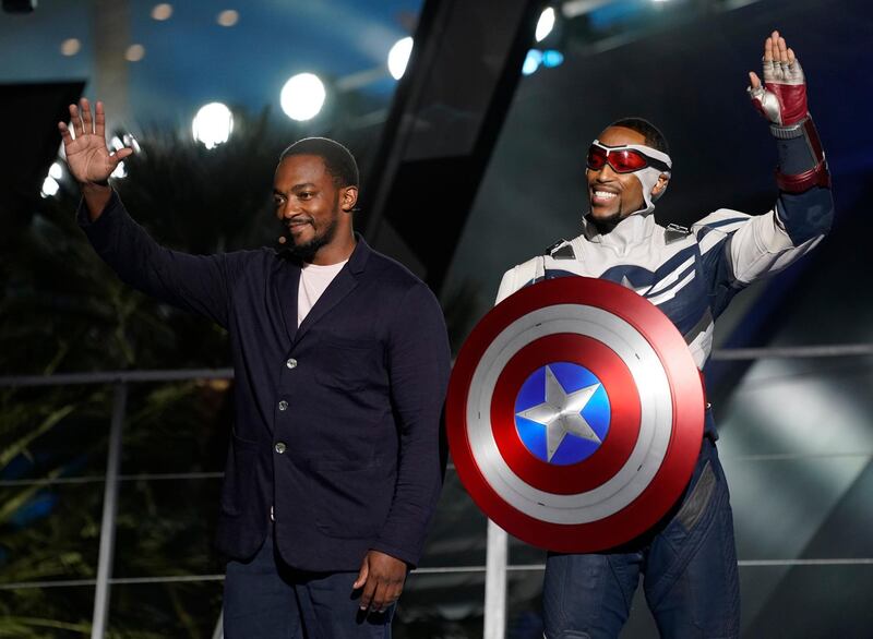 Anthony Mackie, left, and his character Captain America, right, appear on stage at the Avengers Campus dedication ceremony at Disney's California Adventure Park on June 2, 2021. AP