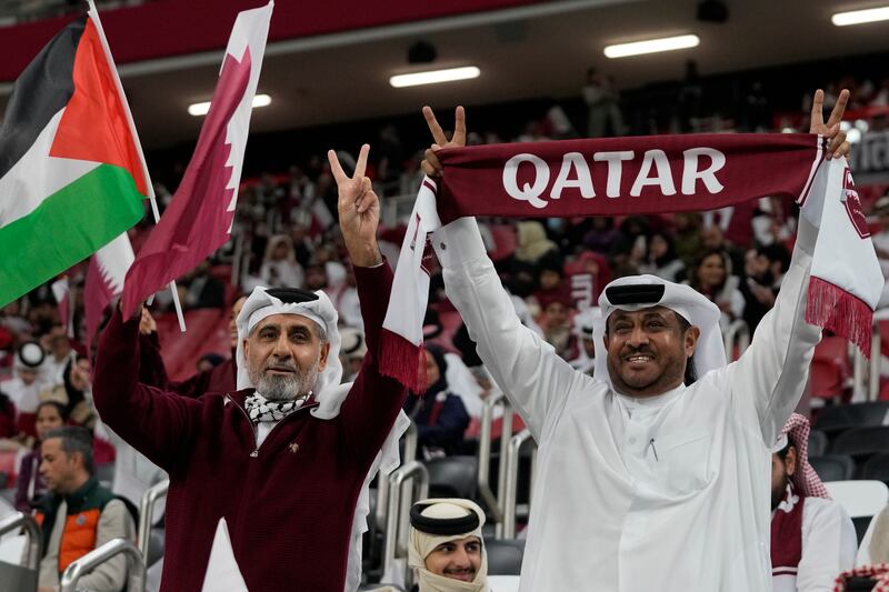 Qatar fans cheer for their team against Uzbekistan. AP