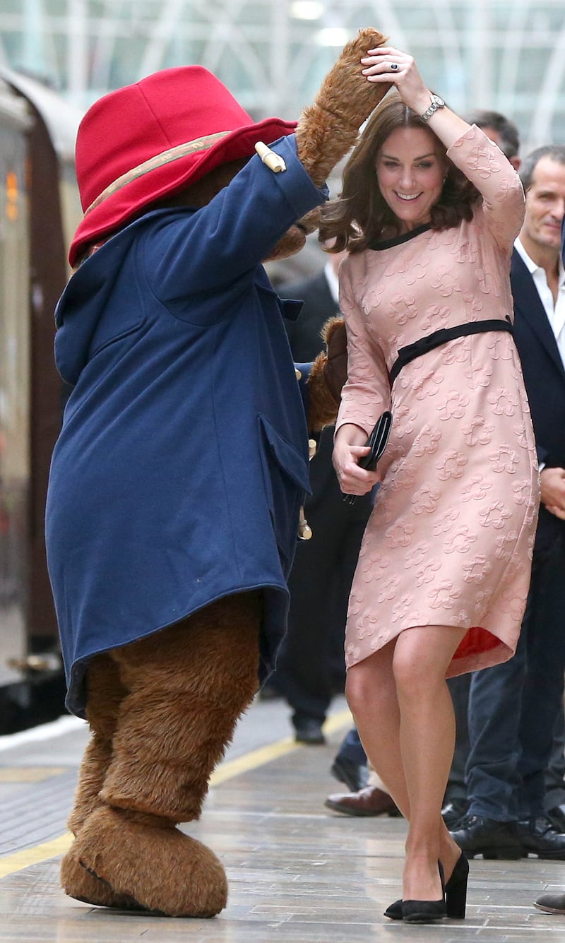 Catherine dances with Paddington Bear as she meets the cast and crew of the film Paddington 2 in London in October 2017