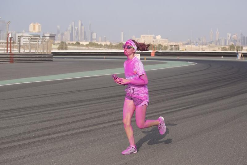 A participant of the Colour Run races to the finish line at the Autodrome. Clint McLean for The National