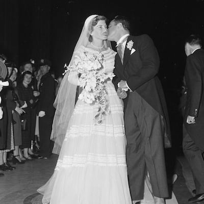 Wearing a gown by Christian Dior, Eunice Kennedy marries Sargent Shriver in 1957. Getty Images 