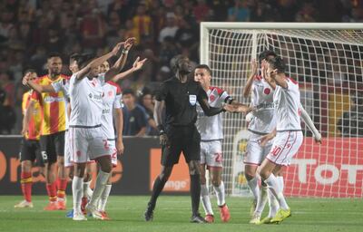 Wydad players ask the referee Gambian Bakary Papa Gassama (C) to check the goal, which was denied by the linesman before finding out the Video assistant referee (VAR) system did not work and the match was interrupted during the 2nd leg of CAF champion league final 2019 football match between Tunisia's Esperance sportive de Tunis and Morocco's Wydad Athletic Club  at the Olympic stadium in Rades on May 31, 2019.
 The VAR did not work and the match was interrupted. / AFP / FETHI BELAID
