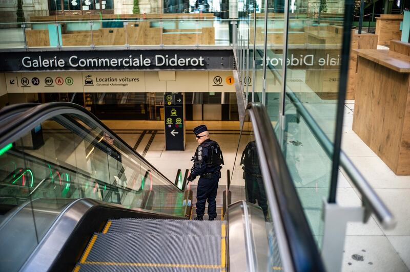A French Police officer patrols inside an empty Gare de Lyon train station in Paris, France, 04 April 2020. EPA