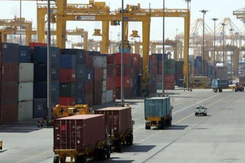 Trucks carry containers from a ship at Jebel Ali port in Dubai 14 March 2006. Dubai Ports World, owned by the United Arab Emirates government, announced on 09 March it would sell its newly acquired rights to operate six US port following overwhelming opposition to the deal in the US Congress. The free trade zone of Jebel Ali is some 40 kilometres (25 miles) from Dubai's centre. AFP PHOTO/RABIH MOGHRABI