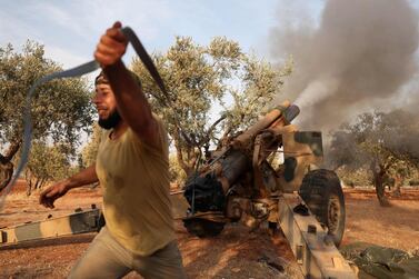 A member of Syria's opposition National Liberation Front fires a 155mm gun towards positions of Russian and regime forces on October 28, 2020, in retaliation to a reported Russian air strike on a training camp 2 days ago, that killed dozens of rebel fighters, in the northwestern Idlib province. / AFP / OMAR HAJ KADOUR