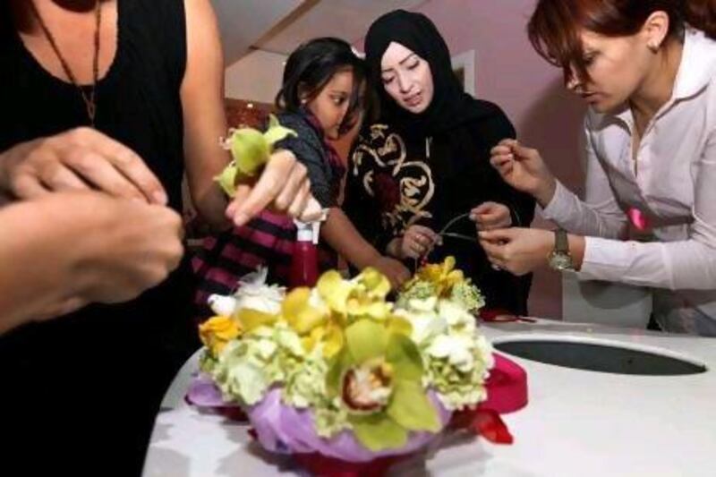 Hanan Abdulla Mousa and her five-year-old daughter Sara make a flower arrangement at the Flower Boutique in Dubai.