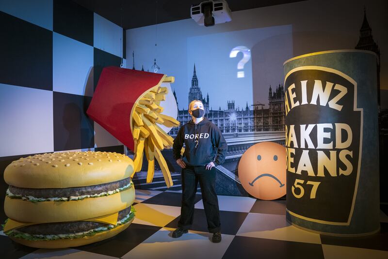 Visitor assistant Rachel Corr stands in the set created for 'I Am Curious, Orange (1988)', which was a collaboration between Michael Clark and post-punk band The Fall, at the preview for the Michael Clark: Cosmic Dancer exhibition at the V&A Dundee on Thursday. PA