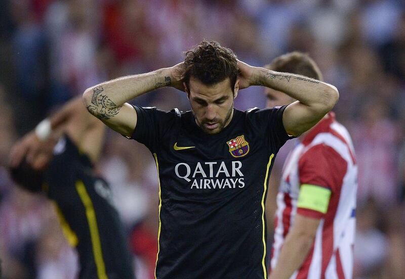 FC Barcelona midfielder Cesc Fabregas places his hands on his head during the Champions League loss to Atletico Madrid. Dani Pozo / AFP / April 9, 2014