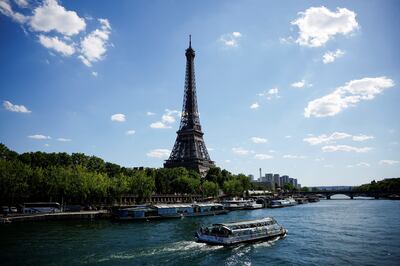 A tourist boat makes it way along the River Seine near the Eiffel Tower in Paris. Reuters