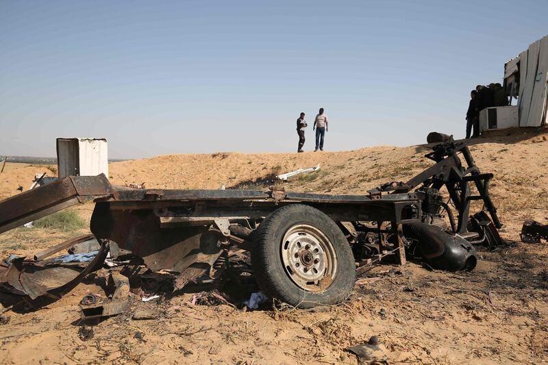 TOPSHOT - Palestinian men are seen walking at the site of an explosion east of Rafah in the southern Gaza Strip, on April 14, 2018.
Four Palestinians were killed in an explosion near the Gaza-Israel border, the health ministry in Gaza said, in circumstances that were unclear. The Hamas-controlled ministry said the explosion east of Rafah was caused by an Israeli strike, but an army spokesman said they no knowledge of any such strike.
 / AFP PHOTO / SAID KHATIB