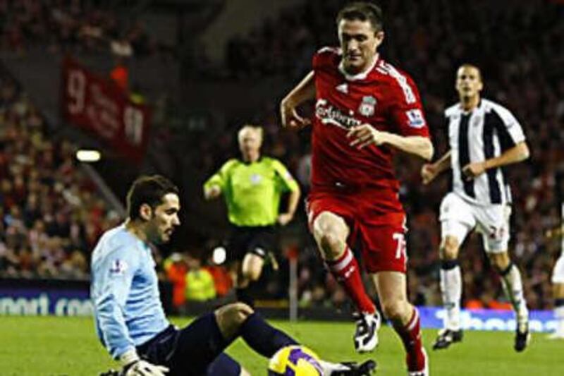 Robbie Keane rounds the West Bromwich Albion goalkeeper Scott Carson to score his second goal in Liverpool's win.