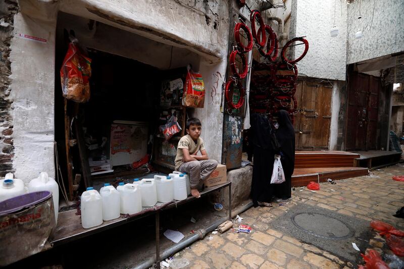 A Yemeni boy waits for customers at a store on World Day Against Child Labour, in Sanaa, Yemen. EPA