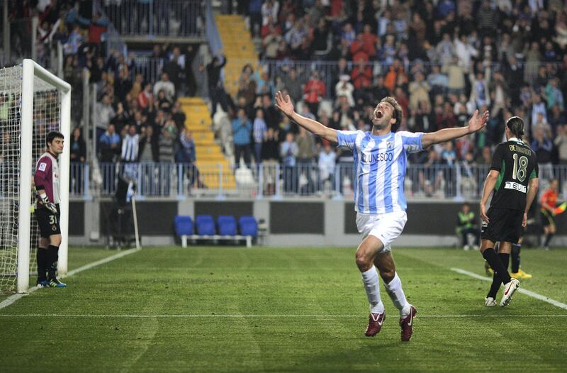 Malaga's Ruud van Nistelrooy celebrates after scoring a goal against Racing Santander during their Spanish First Division soccer match at La Rosaleda stadium in Malaga April 9, 2012. REUTERS/Jon Nazca (SPAIN - Tags: SPORT SOCCER)
