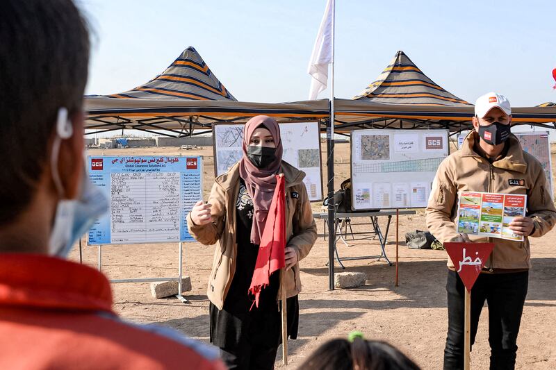 An instructor from Global Clearance Solutions, a private demining company, gives a workshop to children on how to report suspected cases of landmines and unexploded ordnance near the village of Hassan Jalad, north of Iraq's northern city of Mosu. In Hassan Jalad, almost every family has a story to tell of a child, nephew, or brother lost to wartime munitions. The area is littered with unexploded ordnance. AFP