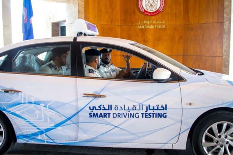 Police officers try out an automated driving test in Abu Dhabi earlier this year. Courtesy Wam