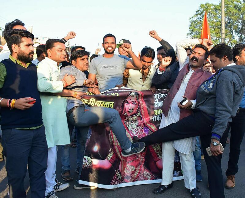 This photograph taken on on January 24, 2018 shows protesters kickicking the a film poster of Bollywood film 'Padmaavat' during a protest against the screening of the movie at Jyoti Chowk in Bhopal.
A controversial Indian movie that has angered Hindu extremists finally opens on January 25 amid heightened security owing to fears of widespread riots. Police are on high alert across several states after protesters pledged to disrupt the release of "Padmaavat", a Bollywood epic about a mythical Hindu queen.
 / AFP PHOTO / DOMINIQUE FAGET