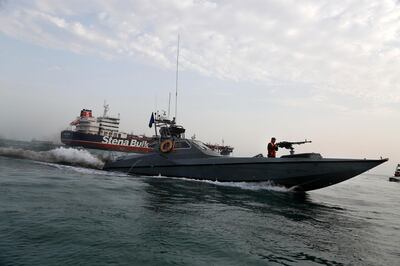 FILE - In this July 21, 2019 file photo, a speedboat of the Iran's Revolutionary Guard moves around a British-flagged oil tanker, the Stena Impero, which was seized by the Guard, in the Iranian port of Bandar Abbas. The U.S. Navy is trying to put together a new coalition of nations to counter what it sees as a renewed maritime threat from Iran. Meanwhile, Iran finds itself backed into a corner and ready for a possible conflict. It stands poised on Friday, Sept. 6, 2019, to further break the terms of its 2015 nuclear deal with world powers. (Hasan Shirvani/Mizan News Agency via AP, File)