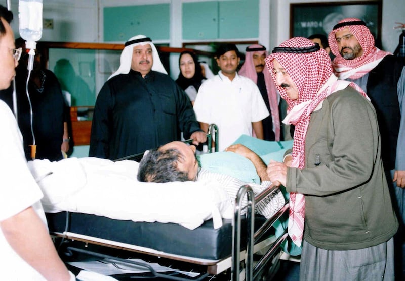 Kuwaiti's first deputy premier, foreign minister and chairman of the Supreme Petroleum Council sheikh Sabah al-Ahmad al-Sabah visits injured oil workers following a blast at the al-Rawdhatain oilfield north of Kuwait, near the border with Iraq. Four people were killed and 19 others injured.      AFP PHOTO/Yasser AL-ZAYYAT (Photo by YASSER AL-ZAYYAT / AFP)