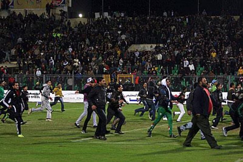 Egyptians football fans invade the pitch following Al Masry's 3-1 against Al Ahly in Port Said.