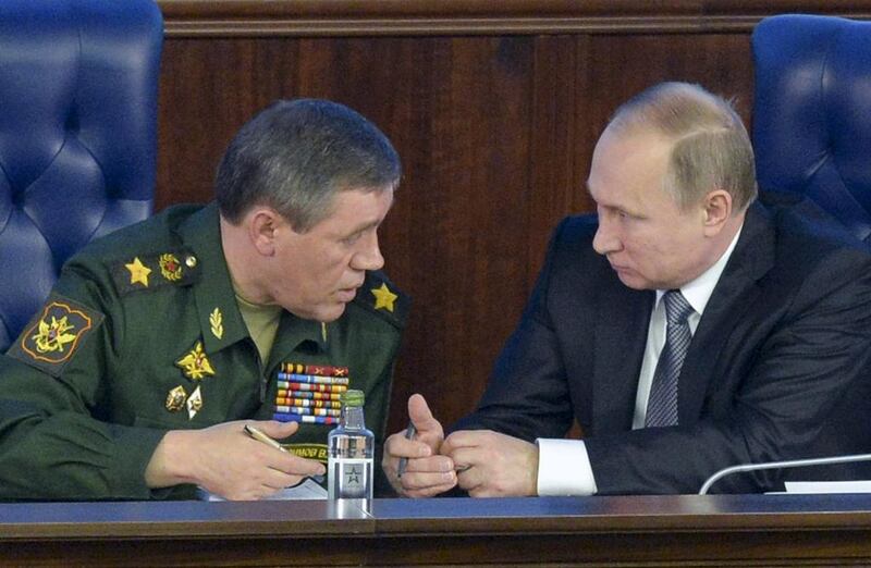 President Vladimir Putin, right, speaks with the head of the Russian armed forces, Valery Gerasimov, at a meeting with top military officials in Moscow on December 11, 2015. Kremlin Pool Photo via AP