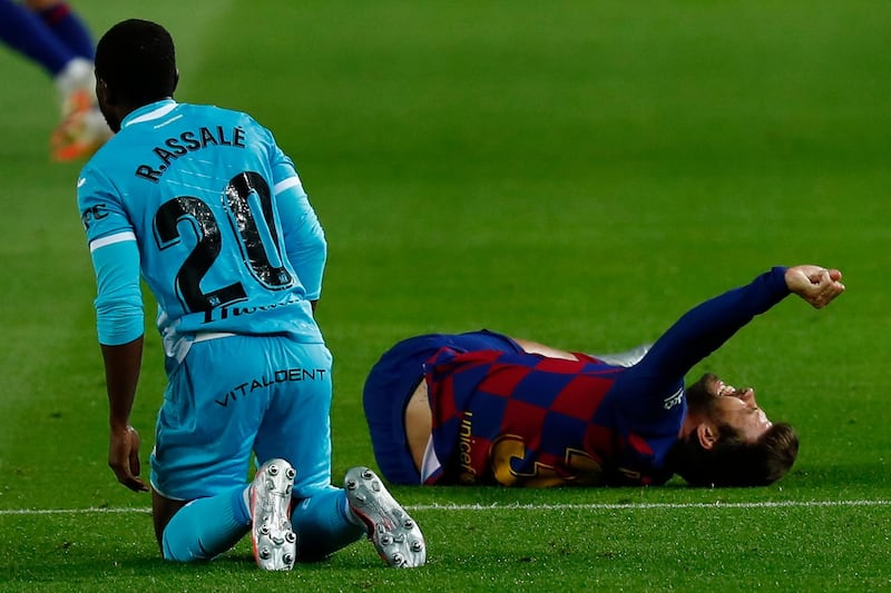 Barcelona defender Gerard Pique grimaces injured against Leganes. AP Photo