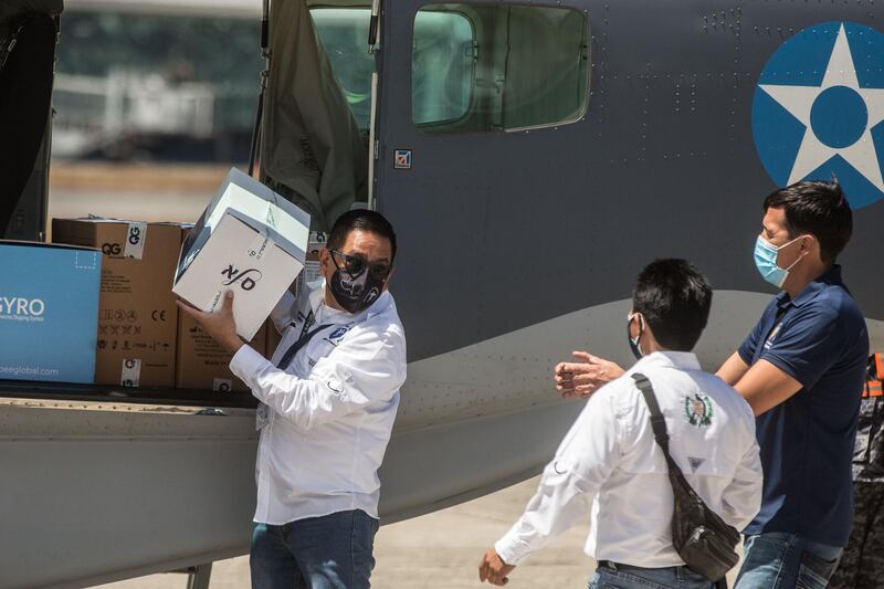 epa09036456 Authorities unload the boxes containing 5,000 vaccines from Modern Pharmaceuticals against COVID-19, donated by the Government of Israel to Guatemala, at the La Aurora International Airport of Guatemala City, Guatemala, 25 February 2021. The 5,000 doses of Moderna's vaccine were transferred to a storage unit and will later be distributed in five hospitals, where they will begin to inject 2,500 people in two phases. The hospitals where the first Guatemalans will be vaccinated are Parque de la Industria, San Juan de Dios, Villa Nueva and Roosevelt, all in the country's capital. In addition, the Quetzaltenango hospital, located in the department of the same name (west).  EPA/Esteban Biba