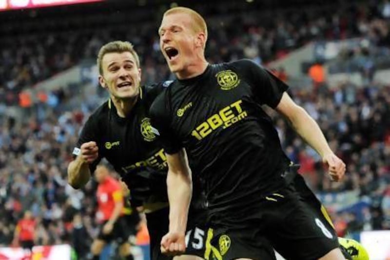 Wigan Athletic's Ben Watson, centre, was told his season was over after a broken leg, but on Saturday scored his and his club's defining goal to win the FA Cup final against Manchester City. Andrew Winning / Reuters