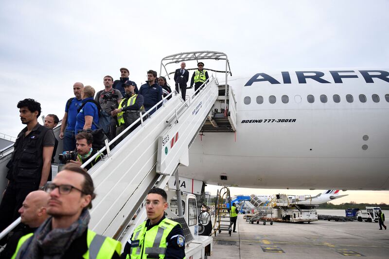 Passengers disembark a plane from Djibouti at Roissy-Charles-de-Gaulle airport near Paris after being evacuated from Sudan. AFP