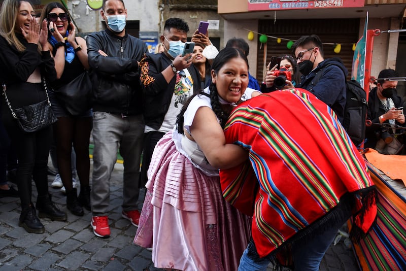 A cholita wrestler incorporates a spectator into her performance during the ElectroPreste festival, which combines traditional and modern customs, in La Paz, Bolivia. Reuters