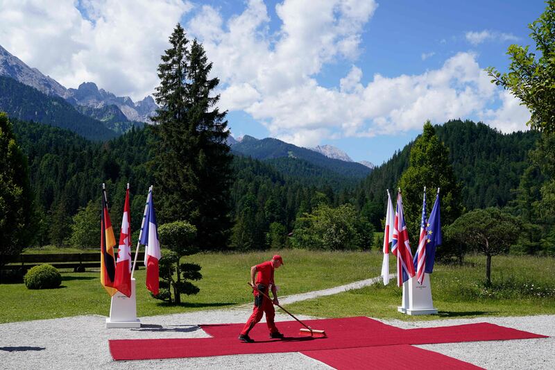 A worker cleans the red carpet at Elmau Castle in the Bavarian mountains. AFP