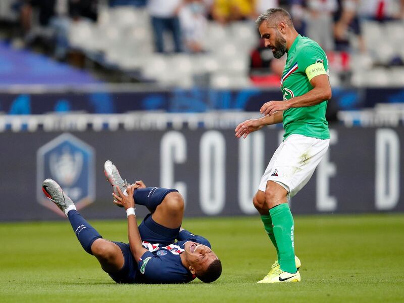 PSG's Kylian Mbappe shouts in pain after being tackled by Saint-Etienne's Loic Perrin, right. AP