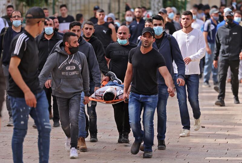 Palestinians rescue a wounded protester at the Damascus Gate in Jerusalem's Old City on May 10, 2021. AFP