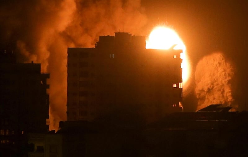 Smoke and flames rise above a building during Israeli air strikes, amid a flare-up of Israeli-Palestinian violence, in Gaza city. Reuters