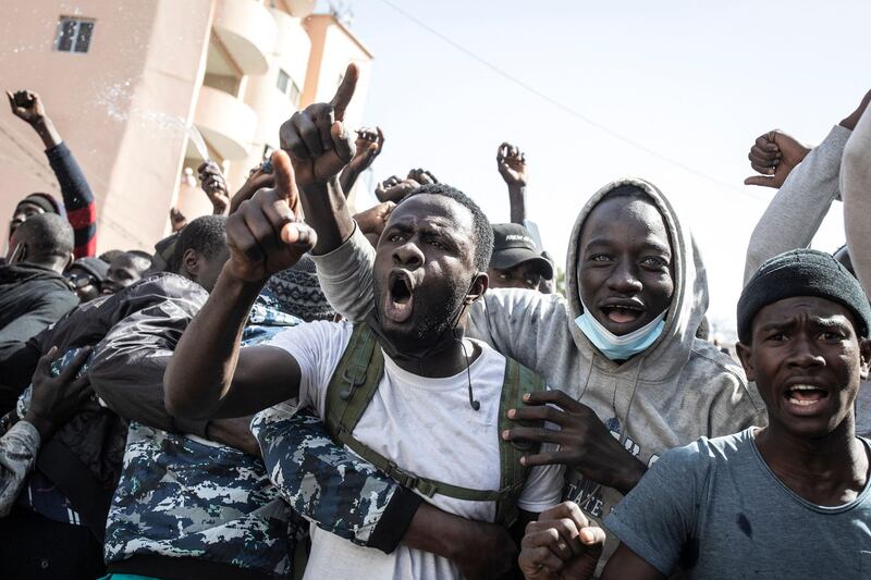 Supporters of opposition candidate Ousmane Sonko call for his release, outside the Justice Palace, Dakar, Senegal, following his arrest over rape charges. AFP