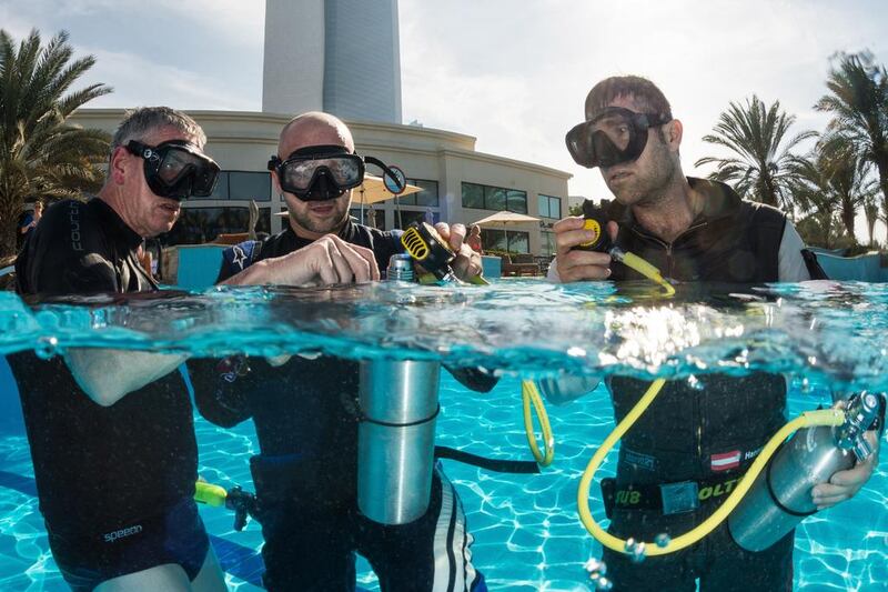 Petr Kopfstein of the Czech Republic and Hannes Arch of Austria seen during the underwater rescue training before the first stage of the Red Bull Air Race World Championship in Abu Dhabi. Predrag Vuckovic / Red Bull