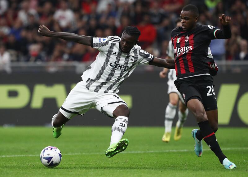 Juventus striker Moise Kean of Juventus is challenged by AC Milan defender Pierre Kalulu. Getty