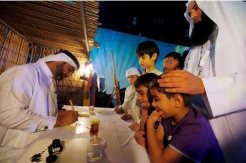 Children have their names written in calligraphy during the Dar Al Ber Society's 8th Annual Orphans Ceremony at the Dubai World Trade Center(DWTC). Satish Kumar / The National