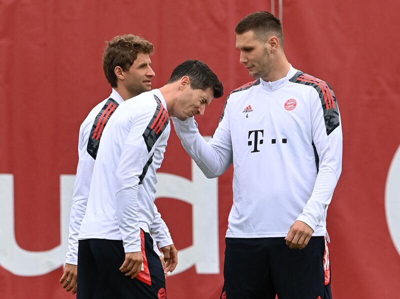 Bayern Munich's Polish forward Robert Lewandowski and Bayern Munich's German defender Niklas Suele joke during a training session. AFP