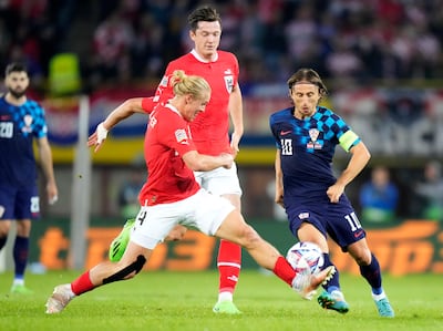 Croatia's Luka Modric, right, duels for the ball with Austria's Xaver Schlager. AP Photo