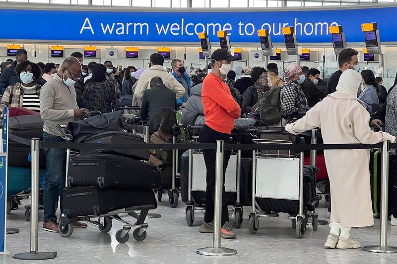 Passengers queue to check in at Heathrow Airport, where passenger numbers slumped because of Covid-19. AP