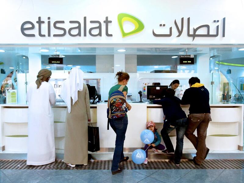 The telco confirmed its net profit after royalties hit Dh2.6 billion during the fourth quarter of last year. Pictured, people at Etisalat booth at Marina Mall in Abu Dhabi. Fatima Al Marzooqi / The National