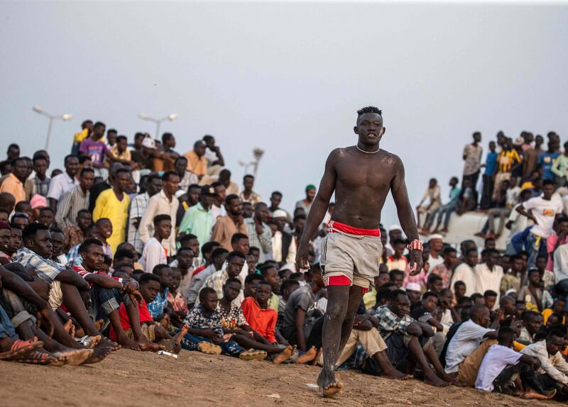 A wrestler approaches by the ring during a traditional Nuba wrestling competition in Sudan's capital Khartoum.