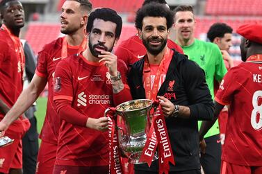 Liverpool's English striker Harvey Elliott wears a mask depicting his teammate Liverpool's Egyptian midfielder Mohamed Salah as he holds with him the trophy and celebrate after winning the English FA Cup final football match between Chelsea and Liverpool, at Wembley stadium, in London, on May 14, 2022.  (Photo by Glyn KIRK  /  AFP)  /  NOT FOR MARKETING OR ADVERTISING USE  /  RESTRICTED TO EDITORIAL USE