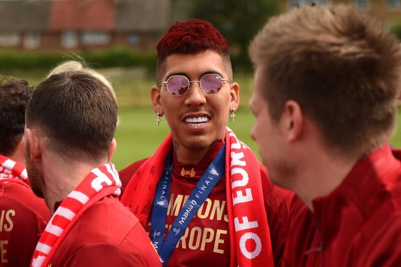 Liverpool's Brazilian midfielder Roberto Firmino reacts during the open-top bus parade around Liverpool. AFP