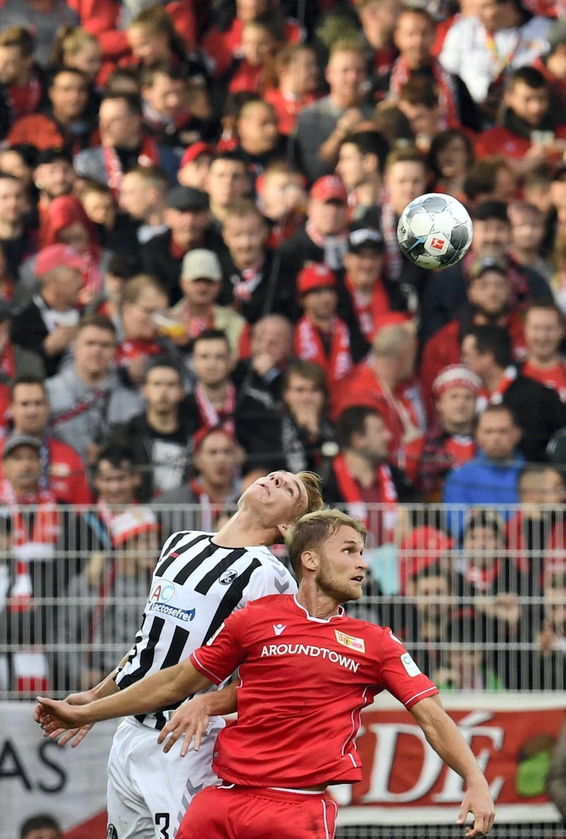 Freiburg's Austrian defender Philipp Lienhart (L) and Union Berlin's Swedish forward Sebastian Andersson vie for the ball during the German first division Bundesliga football match FC Union Berlin v SC Freiburg in Berlin on October 19, 2019. (Photo by John MACDOUGALL / AFP) / RESTRICTIONS: DFL REGULATIONS PROHIBIT ANY USE OF PHOTOGRAPHS AS IMAGE SEQUENCES AND/OR QUASI-VIDEO