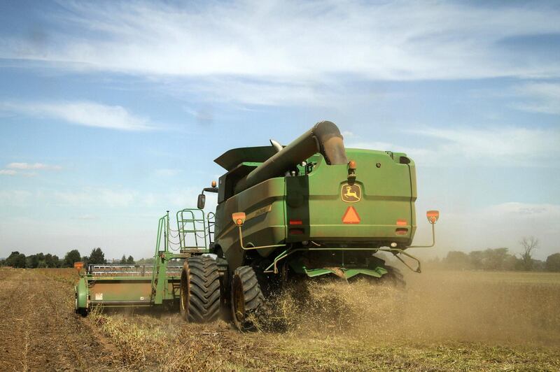 A John Deere S660 combine harvester, manufactured by Deere & Co., harvests a crop of soybean plants in a field in Delmas, South Africa, on Tuesday, April 8, 2014. South African corn stockpiles probably will more than double in 2014-15 after the government predicted this season's harvest will be the biggest since 1981. Photographer: Dean Hutton/Bloomberg