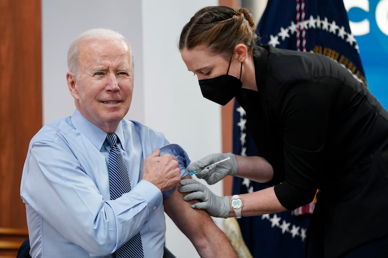 President Joe Biden receives his second Covid-19 booster shot on March 30, 2022, in Washington. AP